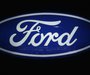Ford cars are reflected in the company's logo at the carmakers' booth on media day at the Paris Mondial de l'Automobile, September 28, 2012.