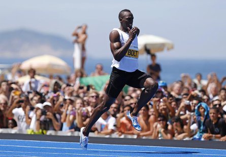 Jamaican Olympic gold medallist Usain Bolt leaps ahead to win the "Mano a Mano Men's 150 metres" challenge on Copacabana beach in Rio de Jan Jamaican Olympic gold medallist Usain Bolt leaps ahead to win the "Mano a Mano Men's 150 metres" challenge on Copacabana beach in Rio de Jan