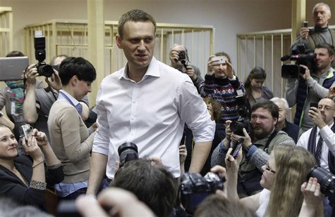 Russian opposition leader and anti-graft blogger Alexei Navalny (C) looks on surrounded by journalists after arriving for a court hearing in Russian opposition leader and anti-graft blogger Alexei Navalny (C) looks on surrounded by journalists after arriving for a court hearing in