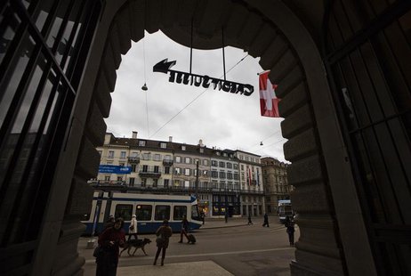 People walk over the Paradeplatz square in front of the Swiss bank Credit Suisse in Zurich, April 12, 2013. Picture taken April 12, 2013. RE People walk over the Paradeplatz square in front of the Swiss bank Credit Suisse in Zurich, April 12, 2013. Picture taken April 12, 2013. RE