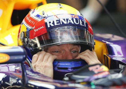 Red Bull Formula One driver Mark Webber of Australia puts on his helmet during the first practice session of the Chinese F1 Grand Prix at th Red Bull Formula One driver Mark Webber of Australia puts on his helmet during the first practice session of the Chinese F1 Grand Prix at th