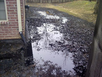 Spilt oil from Exxon pipeline runs between homes in North Woods Subdivision in Mayflower, Arkansas in this April 1, 2013 photo released to R Spilt oil from Exxon pipeline runs between homes in North Woods Subdivision in Mayflower, Arkansas in this April 1, 2013 photo released to R
