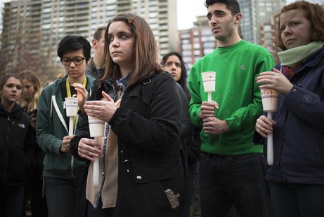 People stand during a vigil honoring the victims of the Boston Marathon bombings at the Boston Common in Boston, Massachusetts April 16, 201 People stand during a vigil honoring the victims of the Boston Marathon bombings at the Boston Common in Boston, Massachusetts April 16, 201