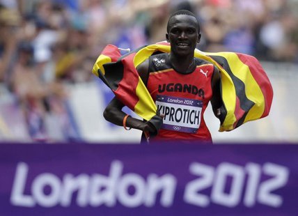 Uganda's Stephen Kiprotich celebrates with his national flag as he approaches the finish line to win the men's marathon in the London 2012 O Uganda's Stephen Kiprotich celebrates with his national flag as he approaches the finish line to win the men's marathon in the London 2012 O