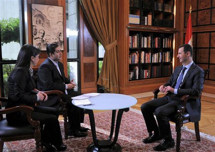 Syria's President Bashar al-Assad (R) attends an interview with Syrian television channel al-Ikhbariya in Damascus, in this handout photogra Syria's President Bashar al-Assad (R) attends an interview with Syrian television channel al-Ikhbariya in Damascus, in this handout photogra