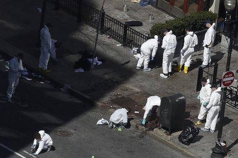 Officials take crime scene photos two days after two explosions hit the Boston Marathon in Boston, Massachusetts April 17, 2013. REUTERS/Sha Officials take crime scene photos two days after two explosions hit the Boston Marathon in Boston, Massachusetts April 17, 2013. REUTERS/Sha