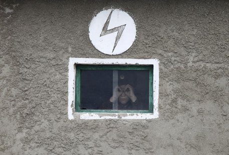 A North Korean soldier looks out of the window of a guard tower, on the banks of Yalu River, about 100 km (62 miles) from the North Korean t A North Korean soldier looks out of the window of a guard tower, on the banks of Yalu River, about 100 km (62 miles) from the North Korean t