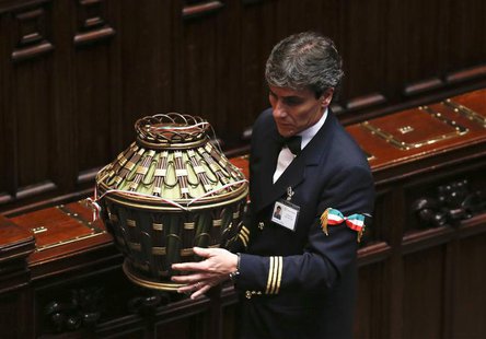 A parliamentary assistant carries a ballot box at the end of the presidential election in the lower house of the parliament in Rome April 18 A parliamentary assistant carries a ballot box at the end of the presidential election in the lower house of the parliament in Rome April 18