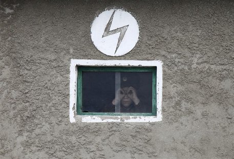 A North Korean soldier looks out of the window of a guard tower, on the banks of Yalu River, about 100 km (62 miles) from the North Korean t A North Korean soldier looks out of the window of a guard tower, on the banks of Yalu River, about 100 km (62 miles) from the North Korean t