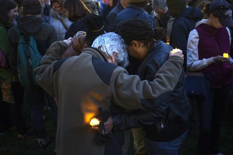 Mourners pray for bomb victims at a vigil outside the Cambridge City Hall, two days after multiple explosions at the Boston Marathon killed Mourners pray for bomb victims at a vigil outside the Cambridge City Hall, two days after multiple explosions at the Boston Marathon killed