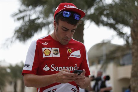 Ferrari Formula One driver Fernando Alonso of Spain checks his mobile phone in the paddock at the Bahrain International Circuit April 18, 20 Ferrari Formula One driver Fernando Alonso of Spain checks his mobile phone in the paddock at the Bahrain International Circuit April 18, 20