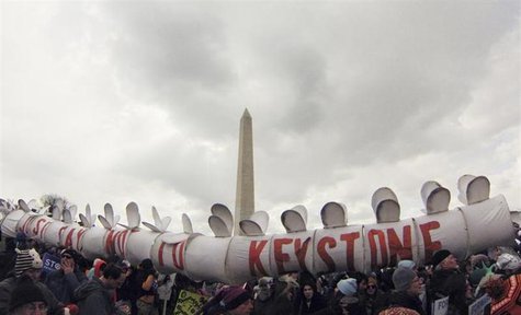 Demonstrators carry a replica of a pipeline during a march against the Keystone XL pipeline in Washington, February 17, 2013. REUTERS/Richar Demonstrators carry a replica of a pipeline during a march against the Keystone XL pipeline in Washington, February 17, 2013. REUTERS/Richar