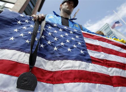 A Boston Marathon runner stands with his medal, which he dyed black, outside the Cathedral of the Holy Cross where United States President B A Boston Marathon runner stands with his medal, which he dyed black, outside the Cathedral of the Holy Cross where United States President B