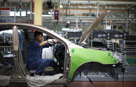 An employee works on the interior of a car along a Geely Automobile Corporation assembly line in Cixi, Zhejiang province in this June 21, 20 An employee works on the interior of a car along a Geely Automobile Corporation assembly line in Cixi, Zhejiang province in this June 21, 20