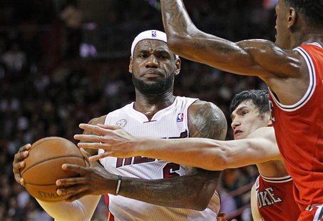 Miami Heat's LeBron James looks to pass as Milwaukee Bucks' Ersan Ilyasova (C) and Larry Sanders (R) defend in the first half of their NBA b Miami Heat's LeBron James looks to pass as Milwaukee Bucks' Ersan Ilyasova (C) and Larry Sanders (R) defend in the first half of their NBA b