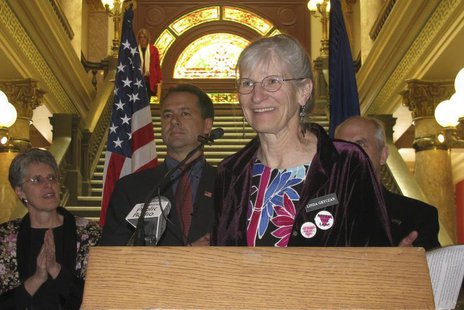 Linda Gryczan talks with reporters as Montana Governor Steve Bullock, (2nd from L) look on at the State Capitol rotunda in Helena, Montana A Linda Gryczan talks with reporters as Montana Governor Steve Bullock, (2nd from L) look on at the State Capitol rotunda in Helena, Montana A