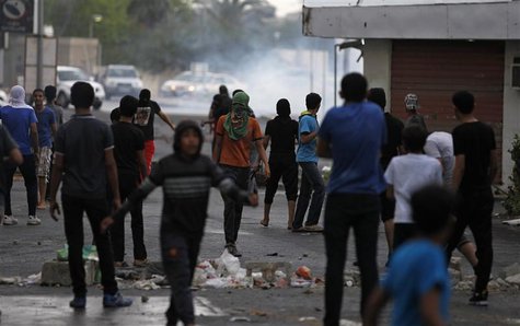 Anti-government protesters stand in front of a teargas cloud fired by riot police during a demonstration in the village of Diraz west of Man Anti-government protesters stand in front of a teargas cloud fired by riot police during a demonstration in the village of Diraz west of Man