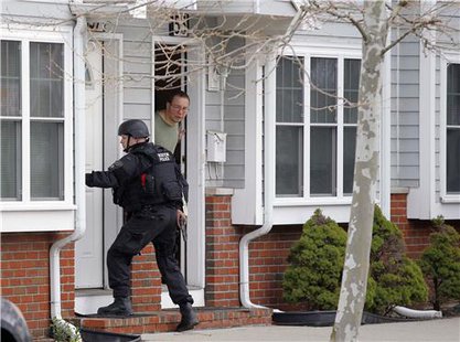 Police search door to door in Watertown, MA (Reuters) Police search door to door in Watertown, MA (Reuters)