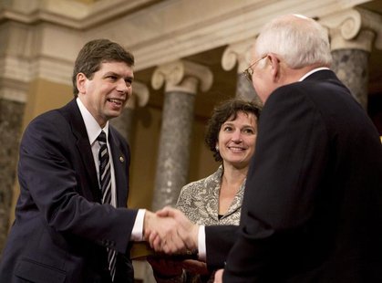 U.S. Sen. Mark Begich (L) (D-AK), accompanied by his wife Deborah Bonito, shakes hands with U.S. Vice President Dick Cheney at the Old Senat U.S. Sen. Mark Begich (L) (D-AK), accompanied by his wife Deborah Bonito, shakes hands with U.S. Vice President Dick Cheney at the Old Senat