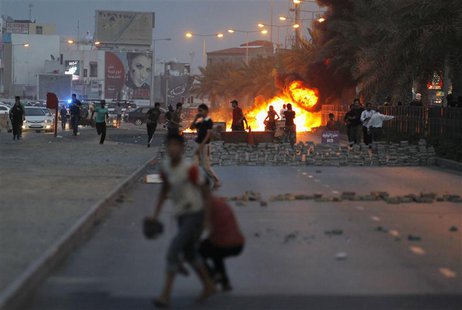 Protesters are seen on a street after setting fire to garbage containers during clashes with riot police in Budaiya, west of Manama April 19 Protesters are seen on a street after setting fire to garbage containers during clashes with riot police in Budaiya, west of Manama April 19