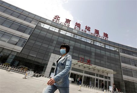 A woman wearing a mask walks outside the Ditan Hospital, where a child with a new strain of bird flu is undergoing treatment, in Beijing Apr A woman wearing a mask walks outside the Ditan Hospital, where a child with a new strain of bird flu is undergoing treatment, in Beijing Apr