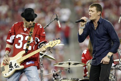 Brad Arnold (R) and Todd Harrell of the rock band "3 Doors Down" perform at halftime during NFL Wild-Card Round playoff football game with t Brad Arnold (R) and Todd Harrell of the rock band "3 Doors Down" perform at halftime during NFL Wild-Card Round playoff football game with t