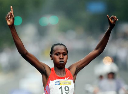 Jeptoo Priscah of Kenya crosses the finish line to win the women's category of the Sao Silvestre street race in Sao Paulo December 31, 2011. Jeptoo Priscah of Kenya crosses the finish line to win the women's category of the Sao Silvestre street race in Sao Paulo December 31, 2011.