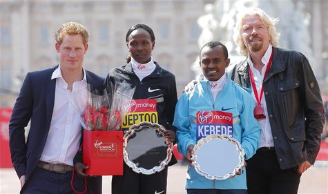 Britain's Prince Harry (L) and Virgin CEO Richard Branson (R) pose on the podium with London Marathon winners Tsegaye Kebede of Ethiopia (2n Britain's Prince Harry (L) and Virgin CEO Richard Branson (R) pose on the podium with London Marathon winners Tsegaye Kebede of Ethiopia (2n