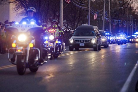 A hearse transporting the body of slain MIT police officer Sean Collier drives down Church Street near the Town Common in Wilmington, Massac A hearse transporting the body of slain MIT police officer Sean Collier drives down Church Street near the Town Common in Wilmington, Massac