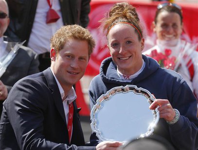 Britain's Prince Harry poses with Tatyana McFadden (R) of the U.S., winner of the women's wheelchair class of the London Marathon, during th Britain's Prince Harry poses with Tatyana McFadden (R) of the U.S., winner of the women's wheelchair class of the London Marathon, during th