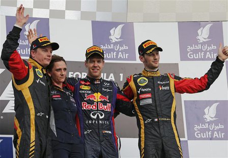 First placed Red Bull Formula One driver Sebastian Vettel of Germany (2nd R), second placed Lotus Formula One driver Kimi Raikkonen of Finla First placed Red Bull Formula One driver Sebastian Vettel of Germany (2nd R), second placed Lotus Formula One driver Kimi Raikkonen of Finla