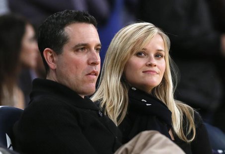 Actress Reese Witherspoon (R) and her husband Jim Toth watch the Toronto Raptors play the Los Angeles Lakers in their NBA basketball game in Actress Reese Witherspoon (R) and her husband Jim Toth watch the Toronto Raptors play the Los Angeles Lakers in their NBA basketball game in