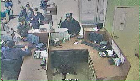 Surveillance photo from the bank during the robbery. Suspect is at the end of the counter. Surveillance photo from the bank during the robbery. Suspect is at the end of the counter.