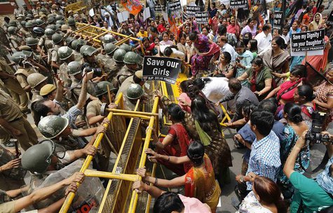 Police try to stop supporters of India's main opposition Bharatiya Janata Party (BJP) as they march towards the residence of the chief of In Police try to stop supporters of India's main opposition Bharatiya Janata Party (BJP) as they march towards the residence of the chief of In