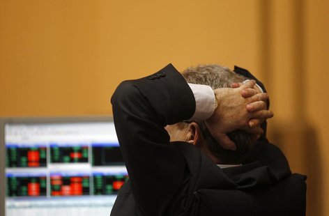 A trader reacts as he looks at screens during trading at the Madrid bourse April 19, 2012. REUTERS/Susana Vera A trader reacts as he looks at screens during trading at the Madrid bourse April 19, 2012. REUTERS/Susana Vera