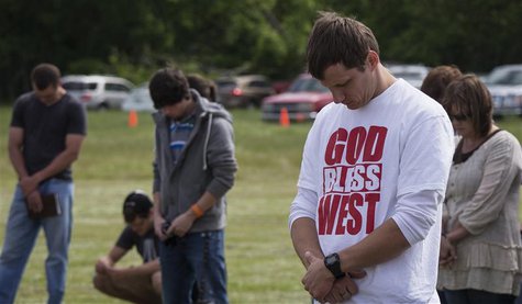 Town residents bow their heads in prayer during an open air Sunday church service four days after a deadly fertilizer plant explosion in the Town residents bow their heads in prayer during an open air Sunday church service four days after a deadly fertilizer plant explosion in the