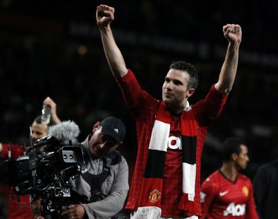 Manchester United's Robin van Persie celebrates after his team clinched the English Premier League soccer title with a win against Aston Vil Manchester United's Robin van Persie celebrates after his team clinched the English Premier League soccer title with a win against Aston Vil