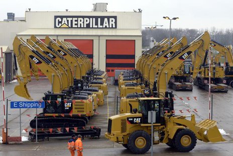 Workers walk past Caterpillar excavator machines at a factory in Gosselies February 28, 2013. REUTERS/Eric Vidal Workers walk past Caterpillar excavator machines at a factory in Gosselies February 28, 2013. REUTERS/Eric Vidal