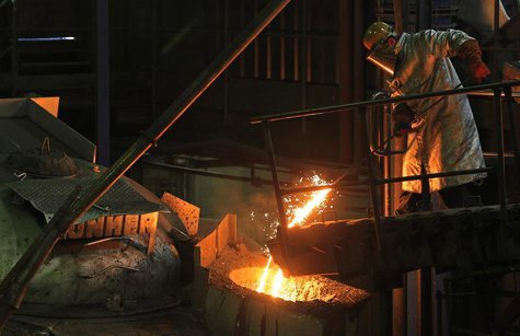 Bernard Mickael, 35, from France, a worker at Belgian company Picanol, demonstrates to Reuters journalists how iron is melted for the compan Bernard Mickael, 35, from France, a worker at Belgian company Picanol, demonstrates to Reuters journalists how iron is melted for the compan