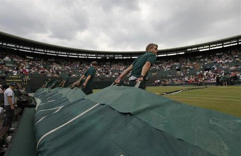 The covers are pulled over number one court as rain stops play in the match between Fernando Verdasco of Spain and Ivo Karlovic of Croatia a The covers are pulled over number one court as rain stops play in the match between Fernando Verdasco of Spain and Ivo Karlovic of Croatia a