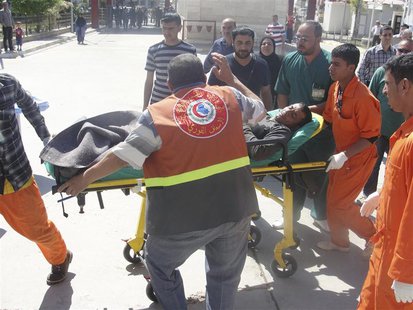 A man is brought to a hospital on a stretcher after after being wounded in a clash between Iraqi forces and Sunni Muslim protesters in Kirku A man is brought to a hospital on a stretcher after after being wounded in a clash between Iraqi forces and Sunni Muslim protesters in Kirku