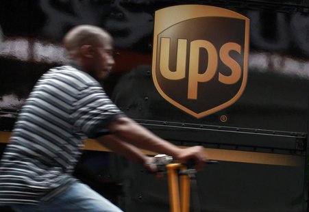 A bicycle delivery man rides past a UPS truck in New York's Times Square, July 23, 2012. REUTERS/Brendan McDermid A bicycle delivery man rides past a UPS truck in New York's Times Square, July 23, 2012. REUTERS/Brendan McDermid