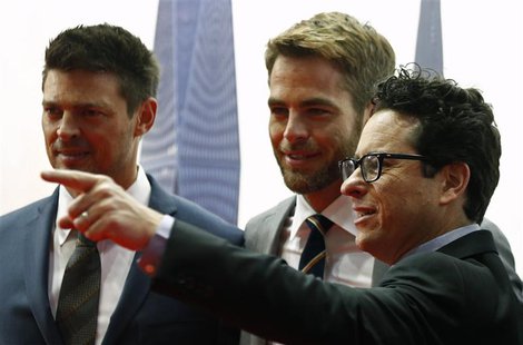 Actors Karl Urban (L) and Chris Pine (C) look on as director J.J. Abrams points to a camera at the red carpet of the Australian premiere of Actors Karl Urban (L) and Chris Pine (C) look on as director J.J. Abrams points to a camera at the red carpet of the Australian premiere of