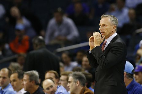Charlotte Bobcats head coach Mike Dunlap watches his team take on the Toronto Raptors during the first half of their NBA basketball game in Charlotte Bobcats head coach Mike Dunlap watches his team take on the Toronto Raptors during the first half of their NBA basketball game in
