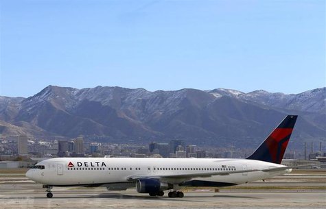 A Delta Airlines Boeing 767 passenger jet taxis past the Salt Lake City skyline, a day before the annual Thanksgiving Day holiday, at the Sa A Delta Airlines Boeing 767 passenger jet taxis past the Salt Lake City skyline, a day before the annual Thanksgiving Day holiday, at the Sa