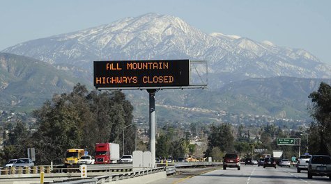 A sign near the San Bernardino Mountains warns of road closures during a manhunt for former LAPD officer Christopher Dorner, wanted in conne A sign near the San Bernardino Mountains warns of road closures during a manhunt for former LAPD officer Christopher Dorner, wanted in conne