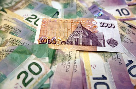 An illustration picture shows one Iceland banknote of one thousand Krona together with Canadian banknotes of five and ten Dollars in Reykjav An illustration picture shows one Iceland banknote of one thousand Krona together with Canadian banknotes of five and ten Dollars in Reykjav