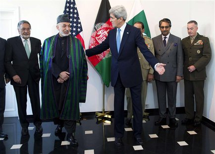 U.S. Secretary of State John Kerry (C) escorts Afghan President Hamid Karzai (2nd L) to a meeting in Brussels April 24, 2013. REUTERS/Evan V U.S. Secretary of State John Kerry (C) escorts Afghan President Hamid Karzai (2nd L) to a meeting in Brussels April 24, 2013. REUTERS/Evan V