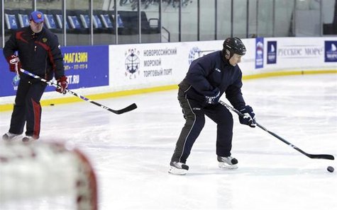 Russia's Prime Minister Vladimir Putin (R) controls the puck, in front of former ice hockey player and recipient of the Honoured Master of S Russia's Prime Minister Vladimir Putin (R) controls the puck, in front of former ice hockey player and recipient of the Honoured Master of S