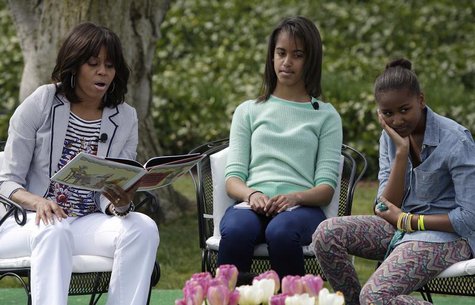 U.S. first lady Michelle Obama (L-R) reads the children's book "Cloudy with a Chance of Meatballs" as her daughters Malia and Sasha look on, U.S. first lady Michelle Obama (L-R) reads the children's book "Cloudy with a Chance of Meatballs" as her daughters Malia and Sasha look on,
